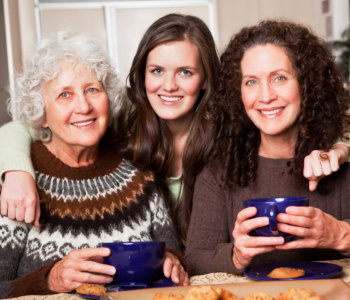 caregiver together with elderly women smiling