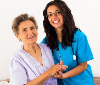 nurse and elder woman smiling